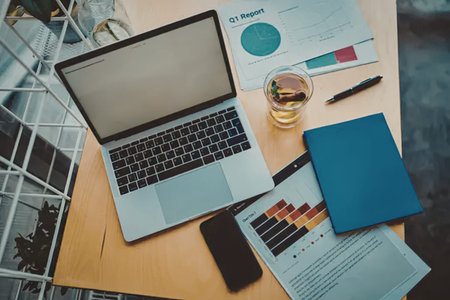 Top view of modern workplace with laptop, mobile phone and coffee cup on wooden table