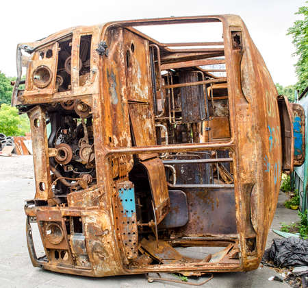 Old rusty bus partially collapsed in the backyardの写真素材