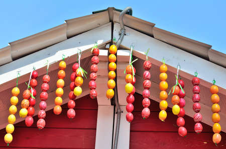 Easter eggs on wooden background. Red houseの写真素材