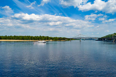 Pedestrian bridge over the Dnieper river. Beautiful view on Trukhaniv bridge and cityscape of Kiev, Ukraineの写真素材