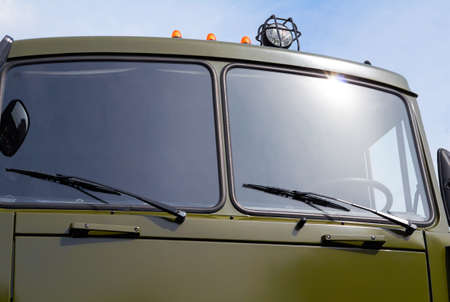Military green truck against the sky