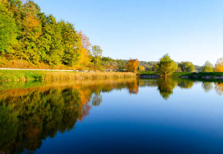 Autumn landscape with a lake view on an autumn afternoonの写真素材