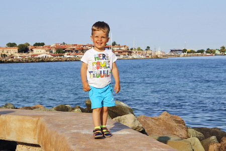 A child walks along the promenadeの写真素材