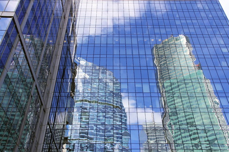 the skyscraper with the reflection of the blue skyの写真素材
