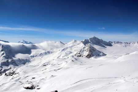 Snowy Mountains in the clouds blue sky Caucasus Elbrusの写真素材