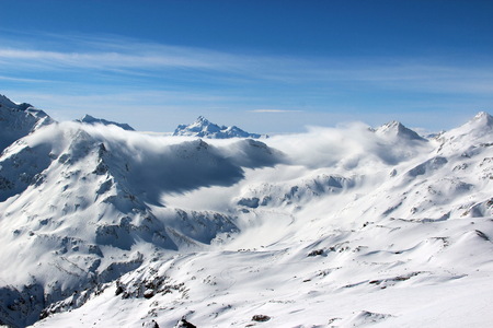Snowy Mountains in the clouds blue sky Caucasus Elbrusの写真素材