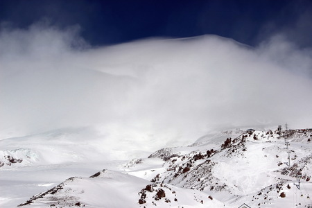 Snowy Mountains in the clouds blue sky Caucasus Elbrusの写真素材
