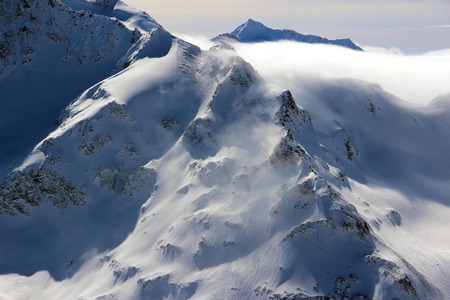 Snowy Mountains in the clouds blue sky Caucasus Elbrus