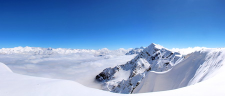 Snowy Mountains in the clouds blue sky Caucasusの写真素材