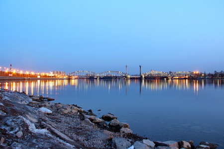 illuminated railway bridge over the river Neva at sunsetの写真素材