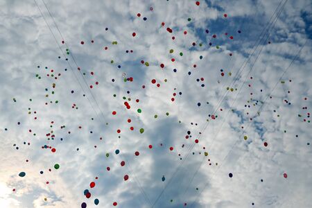 plenty of multicolored balloons in the blue skyの写真素材