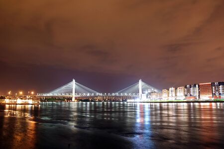 cable-stayed bridge over the river at night with colorful bright lightingの写真素材
