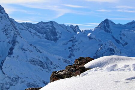 Snowy Mountains peaks in the clouds blue sky Caucasusの写真素材