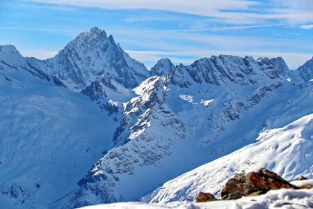 Snowy Mountains peaks in the clouds blue sky Caucasusの写真素材