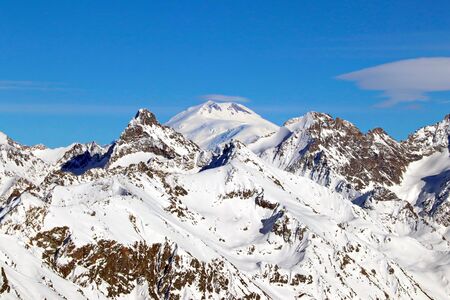 Snowy Mountains peaks in the clouds blue sky Caucasusの写真素材