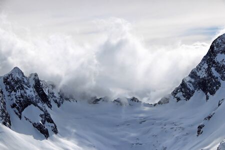 Snowy Mountains peaks in the clouds blue sky Caucasusの写真素材