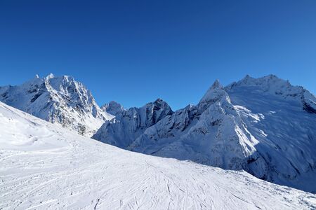 Snowy Mountains peaks and the blue sky Caucasusの写真素材