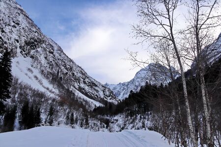 Snowy Mountains peaks in the clouds blue sky Caucasusの写真素材