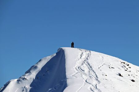 man with snowboard at the top of the snowy mountainの写真素材