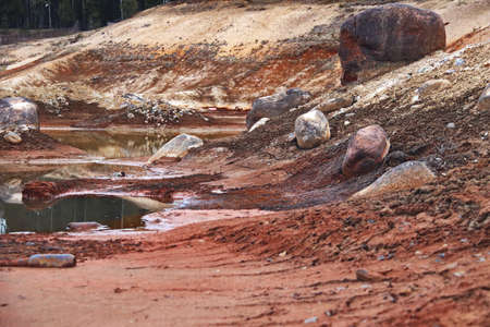 Dirty bottom of a dried-up lake. Ecological problems.
