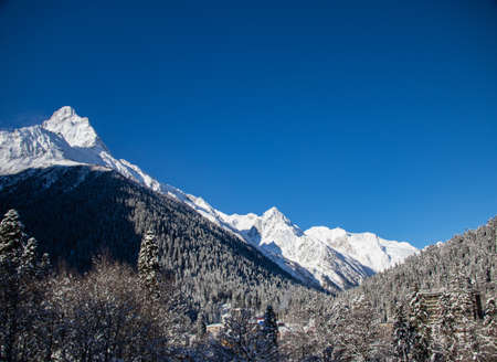 Snowy Caucasus Mountains peaks and clear blue skyの写真素材