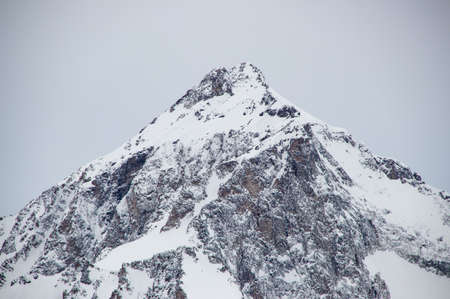 Snowy Mountains peaks in the clouds blue sky Caucasusの写真素材