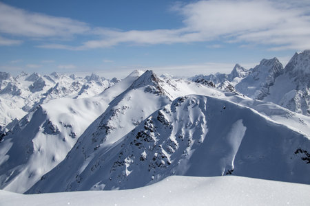 Snowy Mountains peaks in the clouds blue sky Caucasusの写真素材