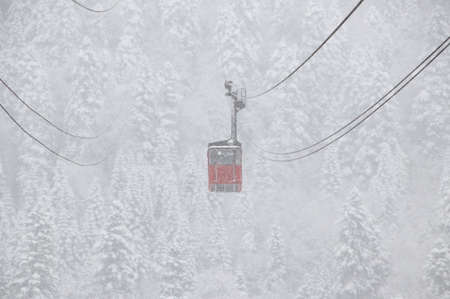 Cableway in the strong snowfall in the mountains of the Caucasusの写真素材