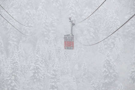 Cableway in the strong snowfall in the mountains of the Caucasusの写真素材