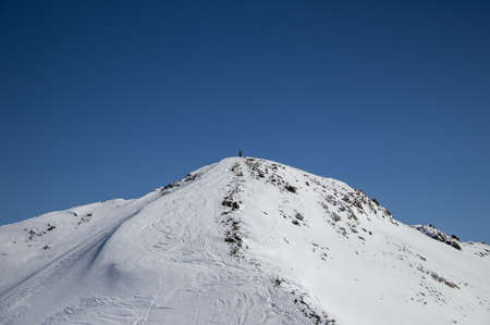 man with snowboard at the top of the snowy Caucasian mountainの写真素材