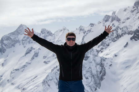 Portrait of a man on top of a snowy mountain.の写真素材