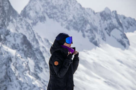 Portrait of a girl on top of a snowy mountain.の写真素材