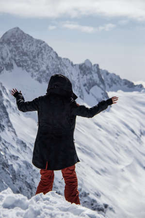 Portrait of a girl on top of a snowy mountain.の写真素材