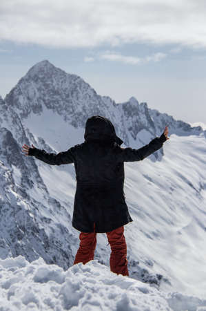 Portrait of a girl on top of a snowy mountain.の写真素材