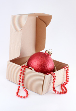 Christmas tree red ball in cardboard box on white backgroundの写真素材
