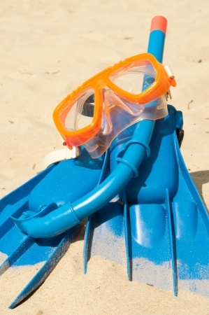 Mask and flippers on a beachの写真素材