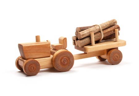 Wooden toy tractor with trailer on white の写真素材