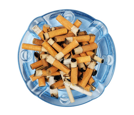 Cigarette butts in the ashtray isolated on whiteの写真素材