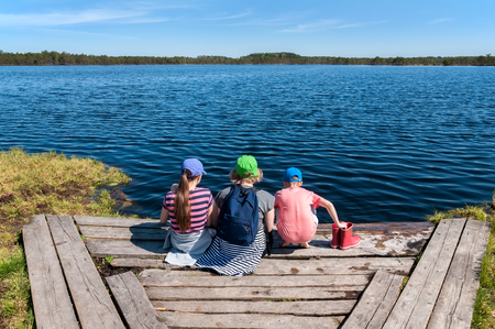 Family summer vacation on the forest lake. Travel, tourism and people conceptの写真素材
