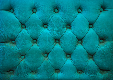 Vintage ocean blue leather upholstery buttoned sofa backgroundの写真素材