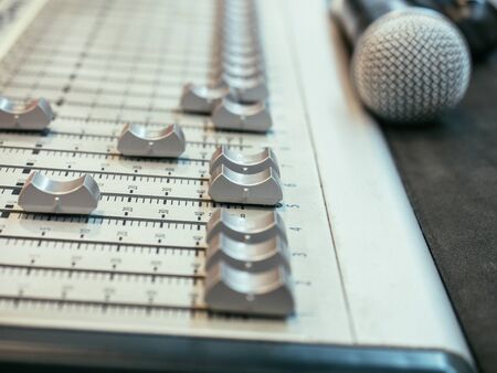 selective focus sound mixer on the blurry microphone background.の写真素材