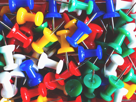 Closeup of colorful thumbtack pinned pile (with shadow and matt color tone)の写真素材