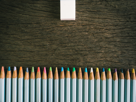 Colorful pencil and rubber arrange on the wooden table symbolized to be a forgiveness,resolving with...