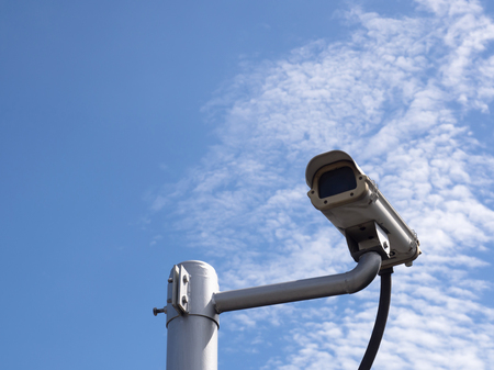 Surveillance Security Camera or CCTV on blue sky background with copy spaceの写真素材