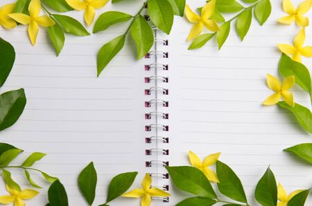 Blank notebook with yellow flowers and green leaves