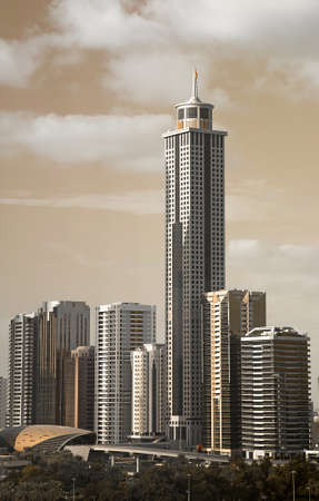 Golden filter on Dubai skyscrapers standing next to each other behind Metro Station の写真素材