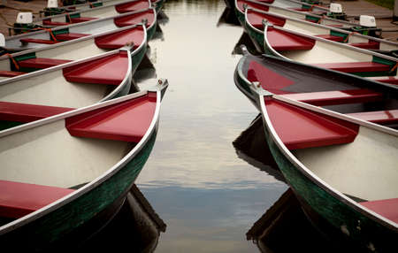Colorful boats parked on a canal in beautiful village of Giethoorn in Netherlands の写真素材