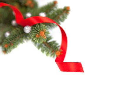 White bright Christmas frame consisting pines from fur tree and red ribbon, including negative empty space for text の写真素材