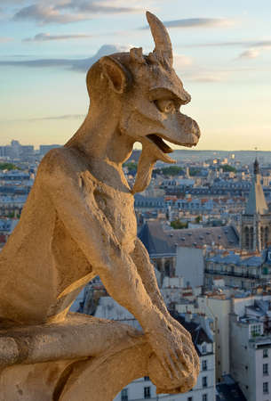 Gargoyle statue on the top of Notre Dame Cathedral in Paris の写真素材