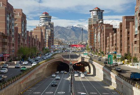 Cars Passing Through Tohid Tunnel of Tehran with Milad Tower and Alborz Mountains in the Background.のeditorial素材